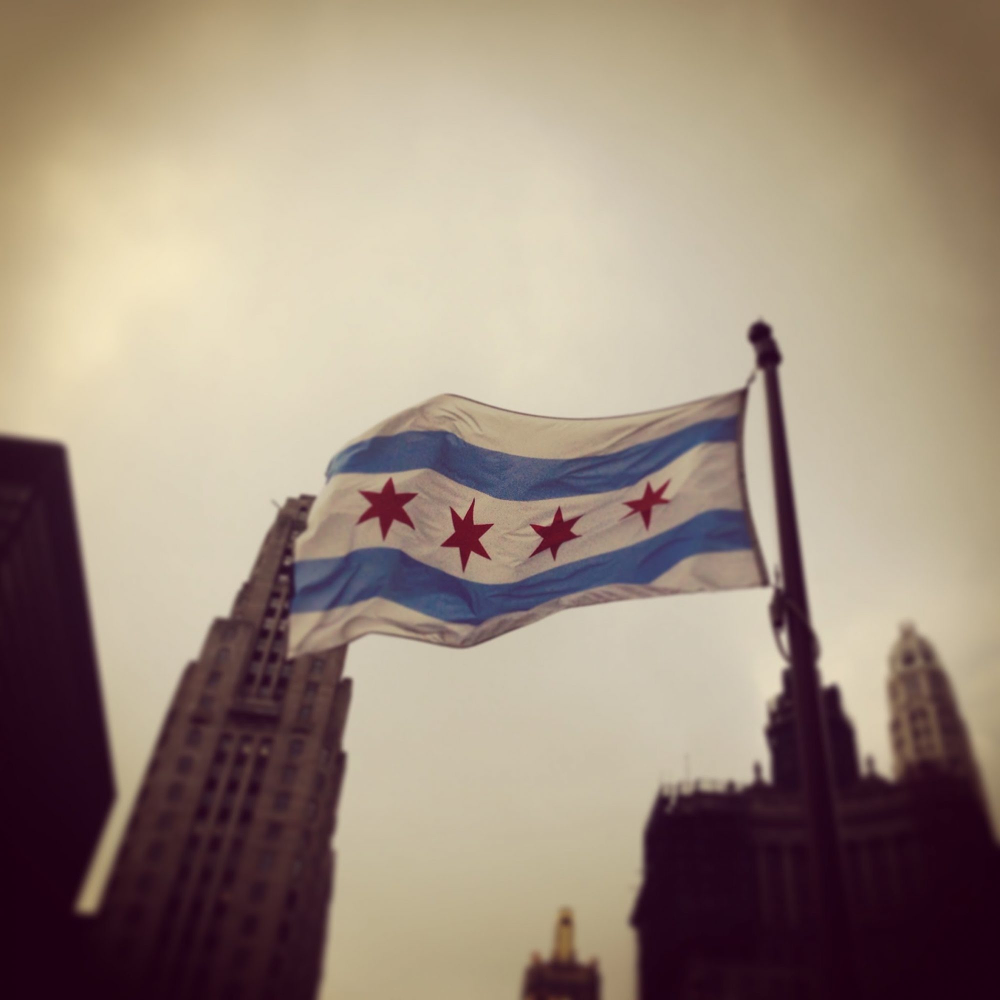 The Chicago flag flying between the Tribune Tower and the Wrigley Building